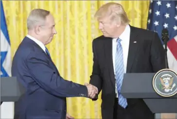  ?? SAUL LOEB/AFP ?? US President Donald Trump (right) and Israeli Prime Minister Benjamin Netanyahu shake hands following a joint press conference in the East Room of the White House in Washington on Wednesday.