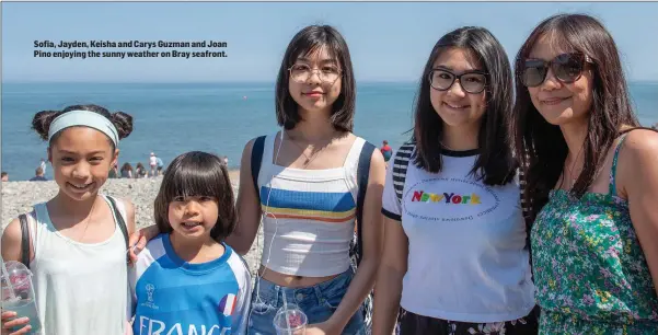  ??  ?? Sofia, Jayden, Keisha and Carys Guzman and Joan Pino enjoying the sunny weather on Bray seafront.