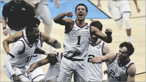  ?? MICHAEL CONROY/AP ?? GONZAGA GUARD JALEN SUGGS (1) CELEBRATES making the game winning basket against UCLA during overtime in a men’s Final Four NCAA college basketball tournament semifinal game Saturday at Lucas Oil Stadium in Indianapol­is.