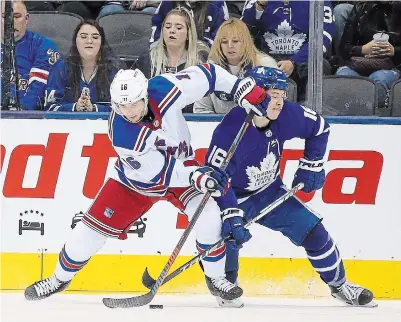  ?? STEVE RUSSELL TORSTAR FILE PHOTO ?? New York’s Ryan Strome, left, knocks Toronto’s Mitch Marner off the puck. Strome led Niagara IceDogs graduates in points during the 2019-20 NHL season.