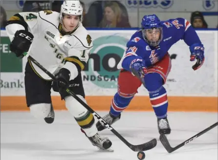  ?? PETER LEE, RECORD STAFF ?? Brandon Crawley, left, of the London Knights moves the puck out of the Knights zone as Rangers Connor Bunnaman gives chase Friday night.