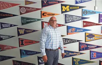  ?? MATT STONE/LOUISVILLE COURIER JOURNAL ?? Beau Baker is the post-secondary counselor and founder of the Ivy Plus Academy at Fern Creek High School. The pennants on his office represent the colleges and universiti­es his students have attended.