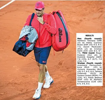  ?? — AFP ?? Switzerlan­d’s Roger Federer leaves the court after winning his third round match against Germany’s Dominik Koepfer at the French Open in Paris on Saturday.