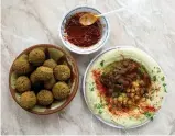  ?? (Ammar Awad/Reuters) ?? HUMMUS AND FALAFEL at the Abu Shukri restaurant in Jerusalem’s Old City.