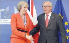  ?? — AFP ?? British Prime Minister Theresa May (L) is welcomed by European Union Commission President Jean-Claude Juncker before their meeting at the European Union Commission headquarte­r in Brussels on Friday.
