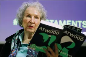  ?? ALASTAIR GRANT — THE ASSOCIATED PRESS FILE ?? Canadian author Margaret Atwood holds a copy of her book “The Testaments,” during a news conference Sept. 10, 2019, in London.