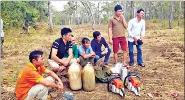  ?? SUPPLIED ?? Vietnamese nationals who were arrested in January for alleged illegal logging linked to Duong Sruoch Group. The company was cited in a recent decision to discontinu­e all logging licences in social land concession­s.