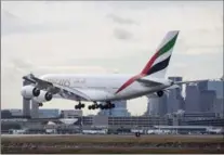  ?? BLOOMBERG ?? An Emirates plane lands at Logan Internatio­nal Airport in Boston.