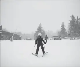  ?? HANNAH YOON ?? A skier heads toward the lifts at Chicopee Ski Club on Saturday. It was the facility’s opening day.