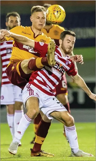  ??  ?? Andy Rose challenges for the ball with Hamilton’s Steven Boyd during his last game for Motherwell