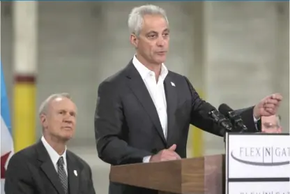  ??  ?? Gov. Bruce Rauner listens as Mayor Rahm Emanuel speaks at Thursday’s opening of Flex- N- Gate’s new factory. | ASHLEE REZIN/ SUN- TIMES