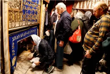  ??  ?? Tourists visit the grotto at the Church of the Nativity in Bethlehem in the occupied West Bank. — Reuters photo