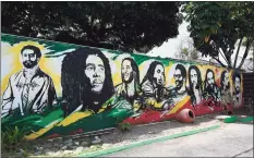 ?? Getty Images ?? A mural of Ethiopian Emperor Haile Selassie I, Jamaican reggae legend Bob Marley and his seven sons stands on the grounds of the Bob Marley Museum in Kingston, Jamaica. State legislator­s, airport officials and others in Connecticu­t and Jamaica are seeking to establish nonstop flights between Bradley Internatio­nal Airport in Windsor Locks and Jamaica.