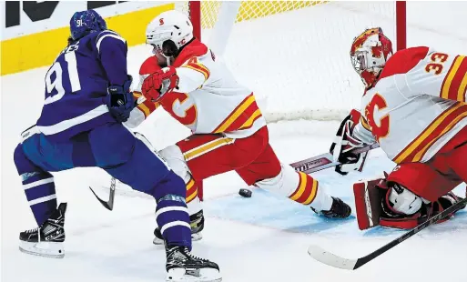  ?? NATHAN DENETTE THE CANADIAN PRESS ?? Flames goaltender David Rittich robs Leaf John Tavares with a stick save on the way to a shutout at Scotiabank Arena on Monday night.