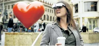  ?? ERIC RISBERG/AP PHOTO ?? Yvonne Felix wears eSight electronic glasses and looks around Union Square during a visit to San Francisco. The glasses enable the legally blind to see. Felix was diagnosed with Stargardt’s disease after being hit by a car as a child.