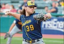  ?? Phil Long / Associated Press ?? Milwaukee Brewers starting pitcher Corbin Burnes delivers against the Cleveland Indians during the first inning of a baseball game in Cleveland on Saturday. Burnes struck out 14 batters in eight innings.