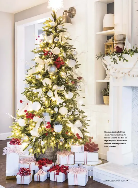  ??  ?? Simple coordinati­ng Christmas ornaments and embellishm­ents keep this Christmas tree clean and bright. Large wire ribbon tied into bows adds to the elegance of the round ornaments.