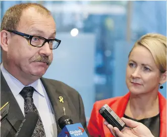  ?? FILES ?? Interim Alberta PC Party leader Ric McIver and party president Katherine O’Neill respond to questions regarding the crossing of the floor by former PC MLA Sandra Jansen to the NDP government.