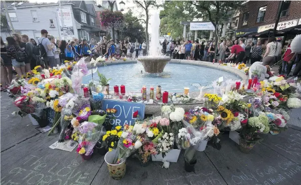  ?? ERNEST DOROSZUK / POSTMEDIA NEWS ?? Flowers surround a fountain at Alexander the Great Parkette, where several people were shot, including teenager Reese Fallon.