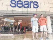  ?? Dylan Baddour / Houston Chronicle ?? Father and son Mike and Kevin Williams cut through Sears on Friday to reach the rest of Baybrook Mall.