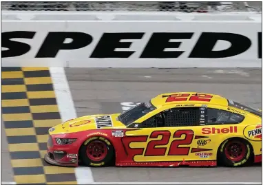  ?? (AP/Orlin Wagner) ?? Joey Logano crosses the finish line to win Sunday’s NASCAR Cup Series race Sunday at Kansas Speedway in Kansas City, Kan., securing a spot in the championsh­ip round of the playoffs. BELOW Logano celebrates in Victory Lane following the race. More photos at arkansason­line.com/1019nascar/.