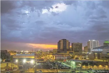  ??  ?? Rain and lightning hit downtown Phoenix on July 30.