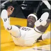  ?? MARK J. TERRILL – AP ?? Lakers guard Dennis Schröder falls after being fouled in the act of shooting during Sunday night’s game against the Warriors.