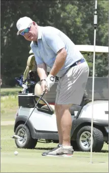  ?? Fred Conley • Times-Herald ?? Rausch Hodges watches his putt during the East Arkansas Community College’s 11th annual golf tournament held Monday at the Forrest City Country Club. Fifteen teams played in the tournament that benefits the college’s foundation. Hodges is a member of the college’s board of trustees. More pictures from the tournament can be found inside today’s Times-Herald.