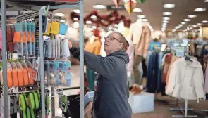  ?? CHARLIE RIEDEL/AP ?? Deanna Bennett shops during a Black Friday sale at a Kohl’s store in Kansas City, Missouri.