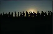  ?? ERIC GAY — THE ASSOCIATED PRESS FILE ?? Migrants who crossed the Rio Grande and entered the U.S. from Mexico are lined up for processing by U.S. Customs and Border Protection on Sept. 23in Eagle Pass, Texas.