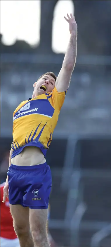  ??  ?? Decaln Byrne gets his hand to a high ball ahead of Clare’s Gary Brennan during their Allianz League Divison 2 clash in Ennis on Sunday.