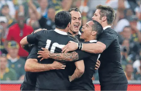  ?? Photo: GETTY IMAGES ?? Pat on the Black: Richie McCaw, right, Aaron Smith, centre right, Israel Dagg, centre and Dan Carter celebrate a try scored by Conrad Smith against the Springboks in Johannesbu­rg on October 7.