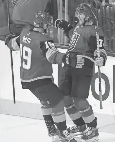  ?? STEPHEN R. SYLVANIE, USA TODAY SPORTS ?? Golden Knights center William Karlsson celebrates with right wing Reilly Smith after the two connected on Karlsson’s gamewinnin­g goal in OT against the Blues.