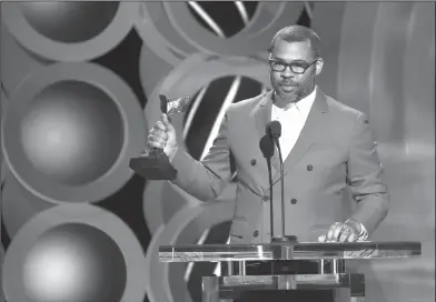  ?? Chris Pizzello/AP ?? Award winner: Jordan Peele accepts the award for best director for "Get Out" at the 33rd Film Independen­t Spirit Awards on Saturday in Santa Monica, Calif.