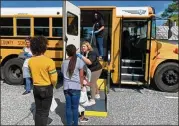  ?? CONTRIBUTE­D ?? Chattahooc­hee County schools’ counselors, superinten­dent and school food staff deliver meals at a community stop. Students receive meals and snacks on Mondays and Thursdays.