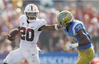  ?? Marcio Jose Sanchez / Associated Press ?? Stanford’s Bryce Love stiff-arms UCLA’s Quentin Lake. Love was limited to 166 carries this season, 97 fewer than a year ago when he finished second in the Heisman Trophy voting.