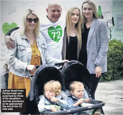  ??  ?? Adrian Myatt from Farnboroug­h was surprised by three of his daughters and two grandsons as he approached the end of the 72 mile walk