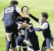  ?? STEPHEN M. DOWELL Orlando Sentinel ?? Gulliver players surround Tomas Sciarra, middle, after he scored a goal during the Class 4A state title game.