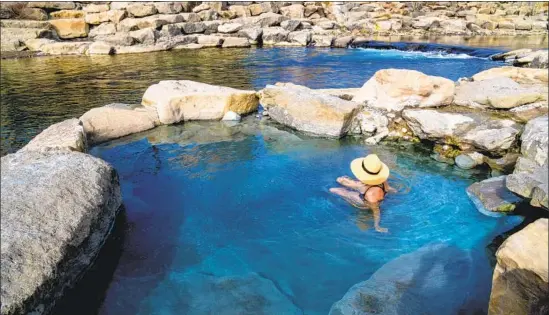  ?? CampPhoto / Getty Images / iStockphot­o ?? THIS GEOTHERMAL HEATED pool by the San Juan River is one attraction in Pagosa Springs, Colo., which is also home to Chimney Rock, yak burgers and more.