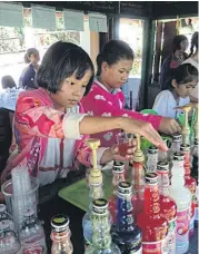  ??  ?? Primary school students try their hand at mixing soft drinks and beverages in the coffee shop.