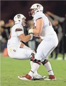  ?? SEAN M. HAFFEY, GETTY IMAGES ?? Thanks to linemen such as A.T. Hall, right, Keller Chryst has not been sacked in four games.