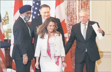  ??  ?? Freeland (front) together with (from left) Canadian Minister of Defence Harjit Sajjan, Pompeo and US Defence Secretary James Mattis walk away after a media availabili­ty after the US-Canada 2+2 Ministeria­l at the State Department in Washington, DC. — AFP photo