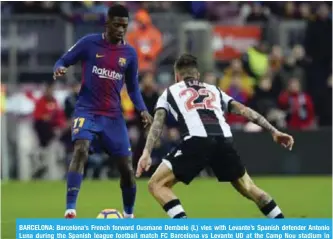  ??  ?? BARCELONA: Barcelona’s French forward Ousmane Dembele (L) vies with Levante’s Spanish defender Antonio Luna during the Spanish league football match FC Barcelona vs Levante UD at the Camp Nou stadium in Barcelona on January 7, 2018. — AFP