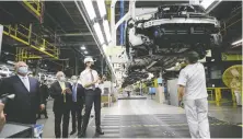  ?? REUTERS ?? Officials including Ontario Premier Doug Ford, left, and Prime Minister Justin Trudeau, centre, visit an Ontario Honda facility in March.