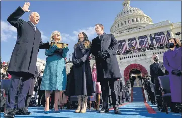  ??  ?? Joe Biden is sworn in as President as First Lady Jill Biden holds the Bible during the inaugurati­on ceremony at US Capitol.