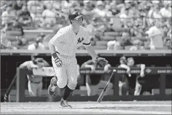  ?? MICHAEL OWENS/AP PHOTO ?? DJ LeMahieu hits the second of his two home runs, a three-run blast, during the fourth inning of the Yankees’ 9-2 win over the Red Sox in Game 1 of a day-night doublehead­er on Saturday in New York.