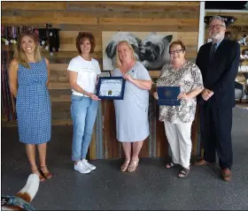  ?? MELISSA SCHUMAN - MEDIANEWS GROUP ?? My Little Dog & Co. owner Renee Murphy, second from left, receives citations from Rensselaer county legislator­s.