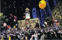  ??  ?? Hello 2021 . . . Marking the arrival of the new year are fireworks in (from clockwise top left) Sydney, Athens and Bangkok and a celebrator­y crowd in Wuhan.