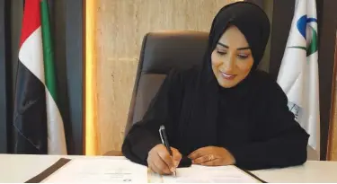  ??  ?? Dr Shaikha Al Dhaheri signing the agreement.