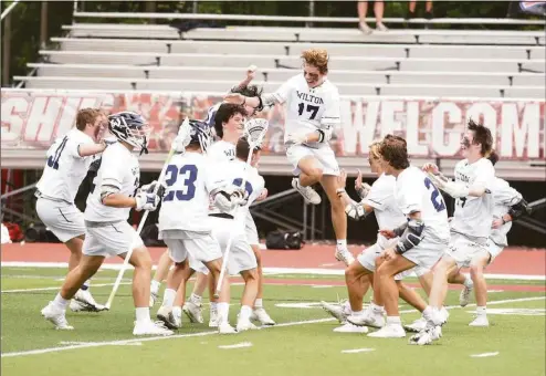  ?? Dave Stewart / Hearst Connecticu­t Media ?? Wilton players celebrate after defeating Notre Dame-West Haven in the Class M final Sunday at Sacred Heart University.